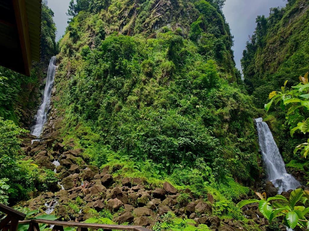 Twin waterfalls of Trafalgar Falls in Dominica, with lush cliffs and volcanic rocks